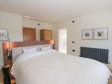 A bedroom with a bed and wardrobe at Brynseion Uchaf near Aberystwyth