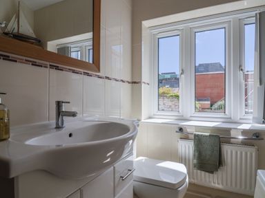 A bathroom with a sink and a toilet at Beck House in Weymouth