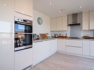 A kitchen with appliances and storage at Serfaus in Perranporth