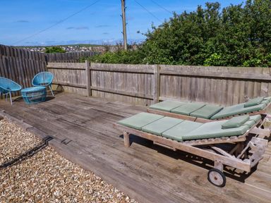 An outdoor space with sun loungers and chairs at Serfaus in Perranporth