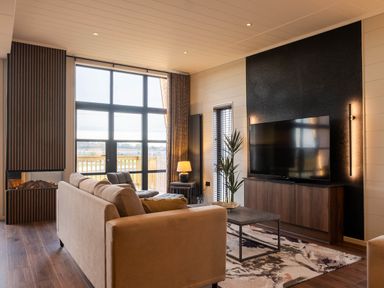 A living room with a TV and a sofa at Exclusive Tempest Spa in Grimsby