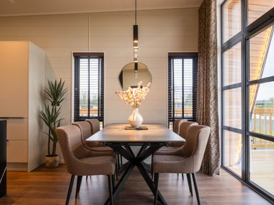 A dining room with a table and chairs at Exclusive Tempest Spa in Grimsby