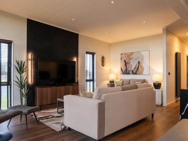A living room with a sofa and television at Exclusive Tempest Spa in Grimsby