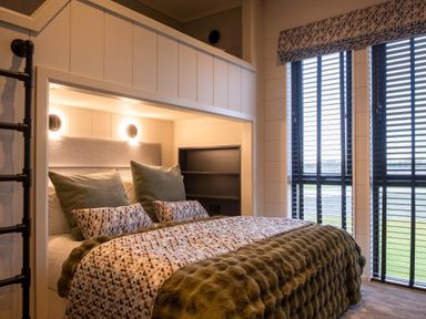 A bedroom with a bed and windows at Exclusive Tempest Spa in Grimsby