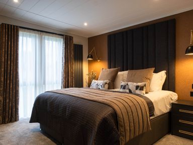 A bedroom with a bed and curtains at Exclusive Tempest Spa in Grimsby