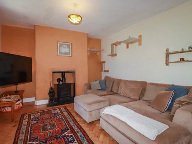 A living room with a sofa and television at 18 Tregea Terrace in Portreath