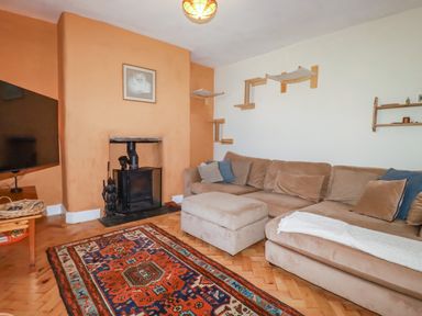 A living room with a TV and a sofa at 18 Tregea Terrace in Portreath