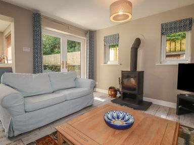 A living room with a sofa and coffee table at Stowaway Cottage Padstow