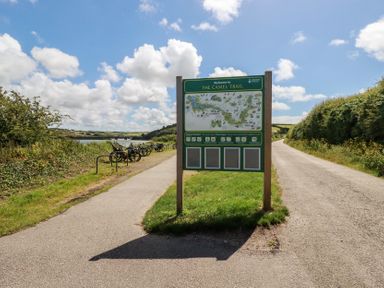 A sign for the Camel Trail with bicycles on the side path at Stowaway Cottage Padstow