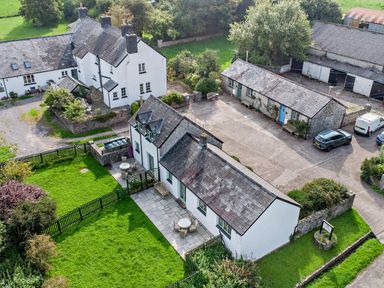 An outdoor view of a property with garden and parking area at Swallow Cottage near Cowbridge