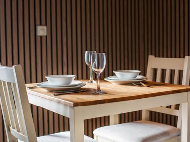 A dining table set with plates and glasses at Pine Lodge Spa in Carlton Miniott near Thirsk
