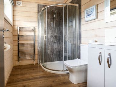 A bathroom with a shower and sink at Pine Lodge Spa Carlton Miniott near Thirsk