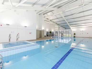 An indoor swimming pool with a jacuzzi at Pine Lodge Spa Carlton Miniott near Thirsk