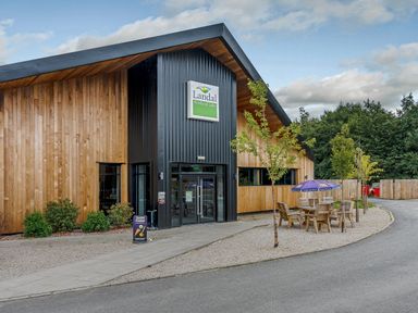 A building with outdoor seating area at Landal Woodland Lakes near Thirsk