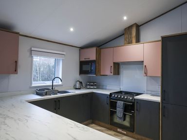 A kitchen with a sink and microwave at Laurel Waterside Spa Carlton Miniott near Thirsk