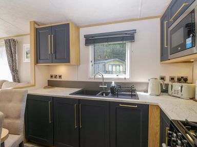 A kitchen with a sink and appliances at 51 Calgarth Park in Troutbeck
