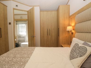 A bedroom with a bed and wardrobe at 51 Calgarth Park in Troutbeck