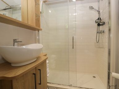 A bathroom with a shower and sink at 51 Calgarth Park in Troutbeck