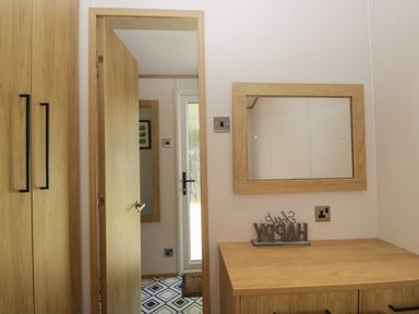 A hallway with a mirror and a wardrobe at 51 Calgarth Park Troutbeck