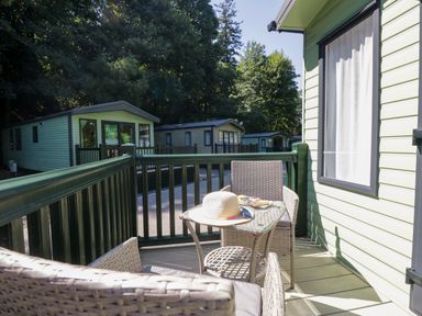 A balcony with chairs and a table at 51 Calgarth Park in Troutbeck