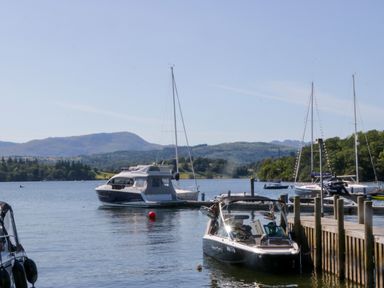 Boats on water with mountains in the background at 51 Calgarth Park, Troutbeck