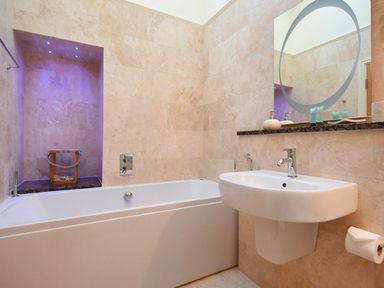 A bathroom with a bath tub and sink at The Chimney in Bamburgh