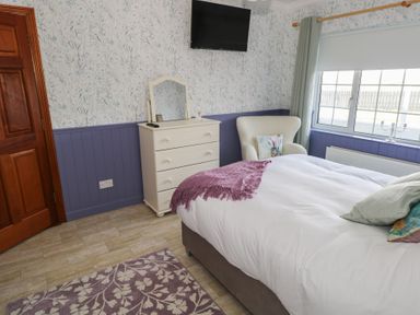 A bedroom with a bed and dresser at Marie's Country Home in Ardee, County Louth