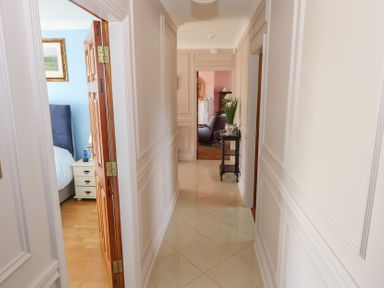 A hallway with doors to rooms and furniture at Marie's Country Home Ardee, County Louth