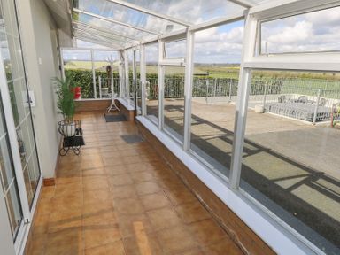 A conservatory with potted plant and coatrack at Marie's Country Home in Ardee, County Louth