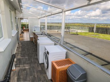 A utility room with washers and a sink at Marie's Country Home Ardee, County Louth