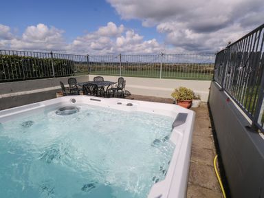 An outdoor area with a hot tub and seating at Marie's Country Home, Ardee, County Louth
