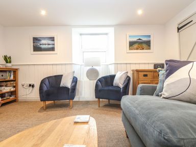 A living room with armchairs and a coffee table at Ty Bryn in Marazion