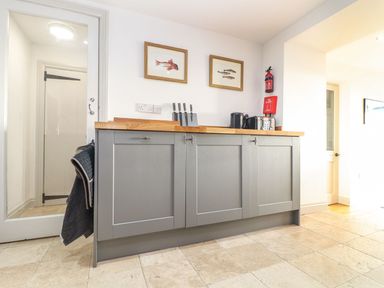 A kitchen with cabinets and countertop at Ty Bryn in Marazion