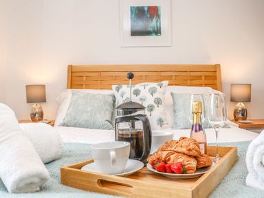 A bedroom with breakfast on a tray at Ty Bryn in Marazion