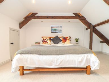 A bedroom with a bed and artwork at Ty Bryn in Marazion