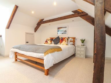 A bedroom with a bed and nightstand at Ty Bryn in Marazion