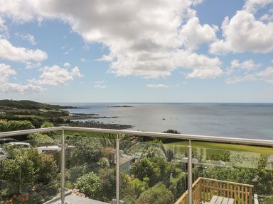 An outdoor view of the ocean and garden at Ty Bryn in Marazion