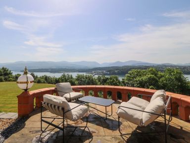 A garden with outdoor seating and a table at Apartment 1, Bryn Mel Manor in Menai Bridge