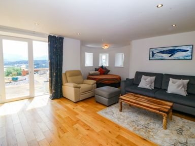 A living room with a sofa and coffee table at Apartment 1, Bryn Mel Manor Menai Bridge