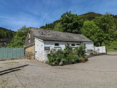 An outdoor view of a cottage with a parking sign at Daffodil Cottage in Blaencwm near Treorchy