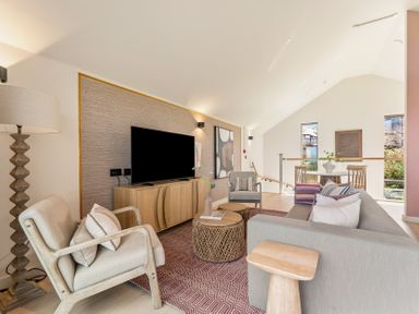 A living room with a television, sofa and armchair at Clifftop House Hot Tub, St Ives