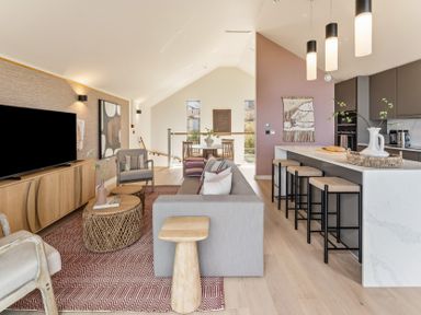 A living room with a television, sofa, and dining area at Clifftop House Hot Tub in St Ives