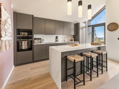 A kitchen with countertop and stools at Clifftop House Hot Tub in St Ives
