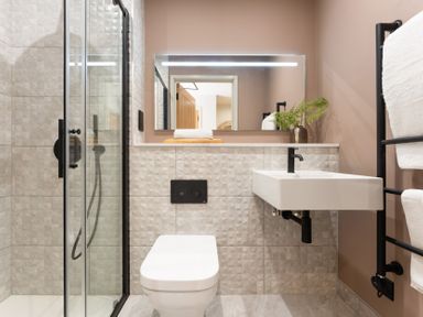A bathroom with a shower, toilet, and sink at Clifftop House Hot Tub in St Ives