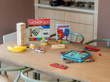 A dining table with board games at Hidden 1- Clifftop House Hot Tub in St Ives
