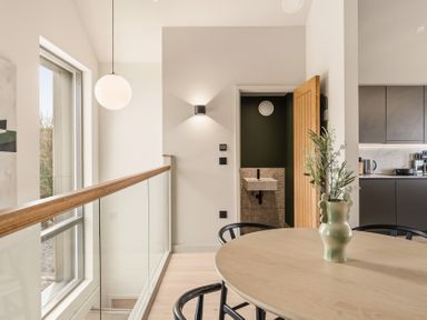 A kitchen with a table and chairs at tbc in St. Ives