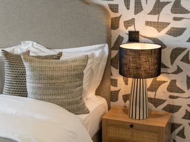A bedroom with pillows and a lamp on a nightstand at tbc in St. Ives