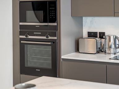A kitchen with built-in oven and microwave at tbc in St. Ives