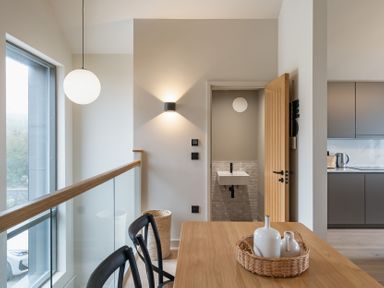 A dining area with a table and a sink visible at tbc St. Ives