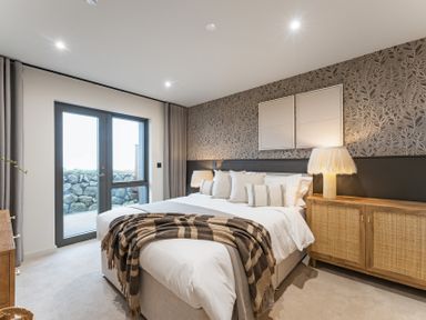 A bedroom with a bed and side table at tbc in St. Ives